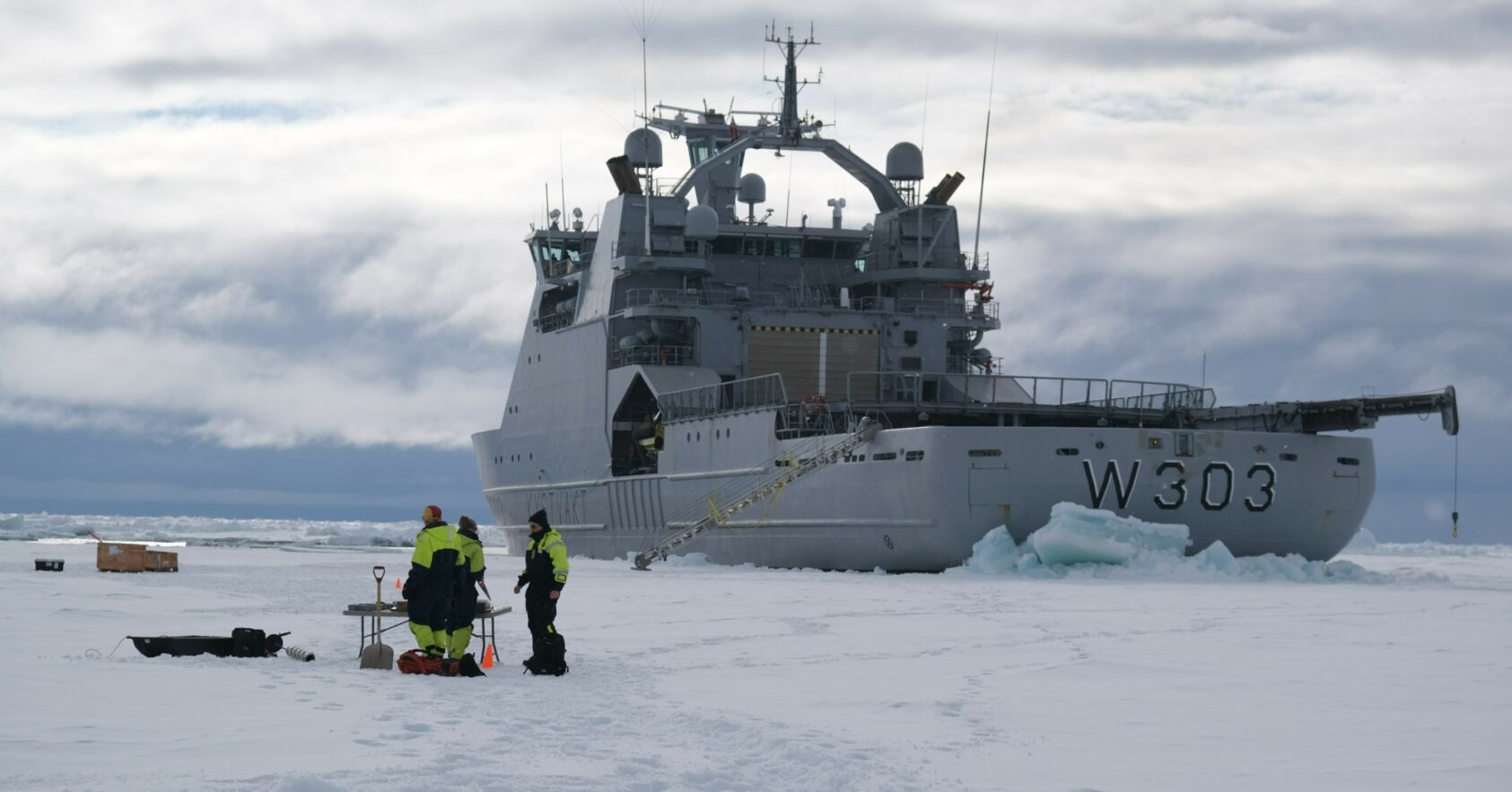 Jozef Rusin/MET, In addition to making ice observations from satellites, drones and the bridge, the team investigated ice properties such as density and salinity by drilling ice cores and studied the snow lying on top of the ice. The team is shown with KV Svalbard in the background., Figure 72, , 