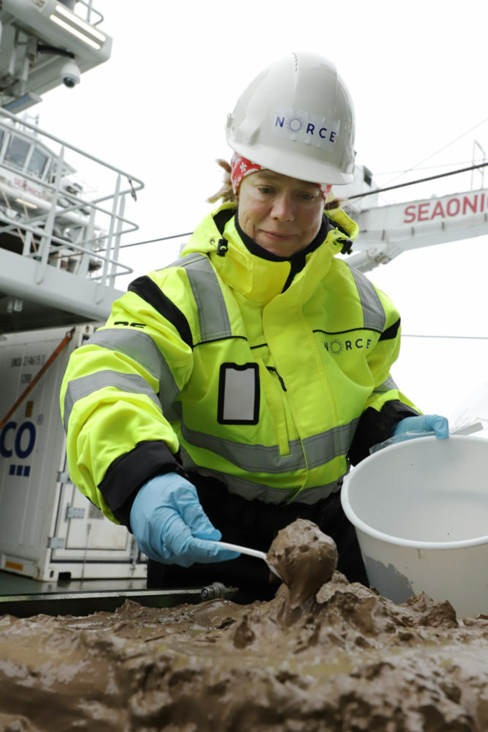 Daniel Albert, SINTEF, Her overfører Katja Häkli (NORCE) sedimenter til en bøtte for senere analyse., Katja riktig, <p><em>Foto: Daniel Albert, SINTEF</em></p>, 