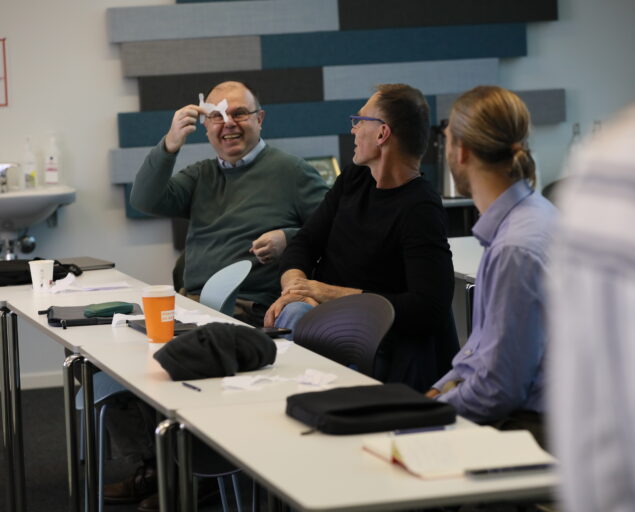 Photo: Thomas Hovmøller Ris, , 0 S0 A0933, , Man showing a piece of paper to two other persons